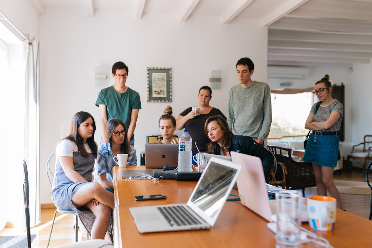 services-04 Group of young professionals engaged in a collaborative meeting in a modern office setting.